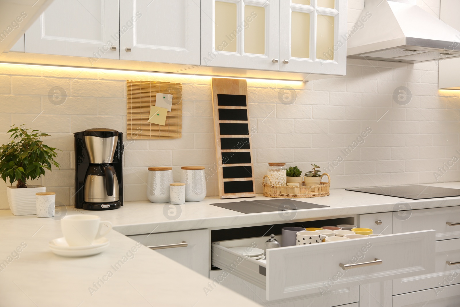 Photo of Stylish kitchen interior with modern coffeemaker on countertop