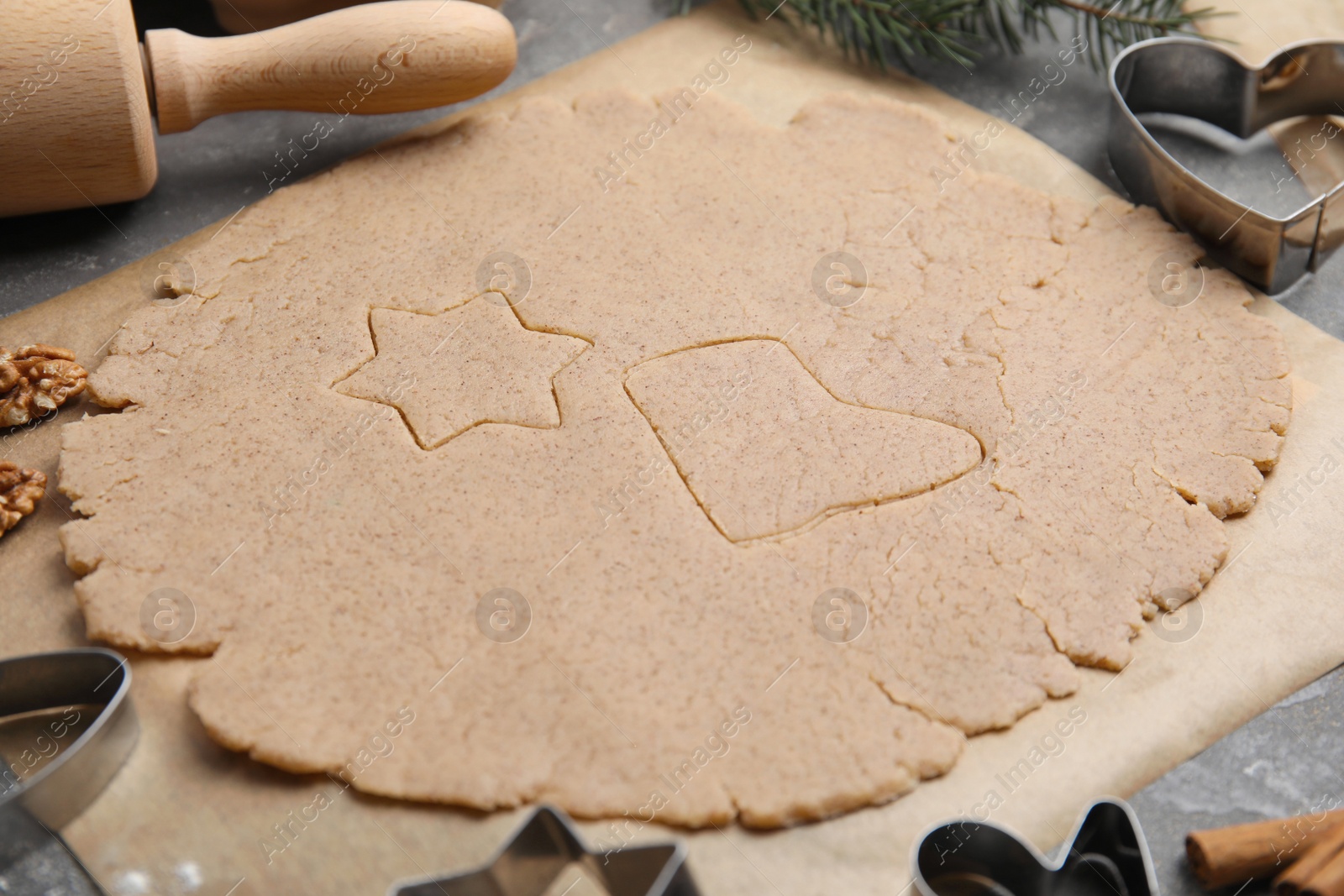Photo of Homemade Christmas cookies. Raw dough on grey table, closeup