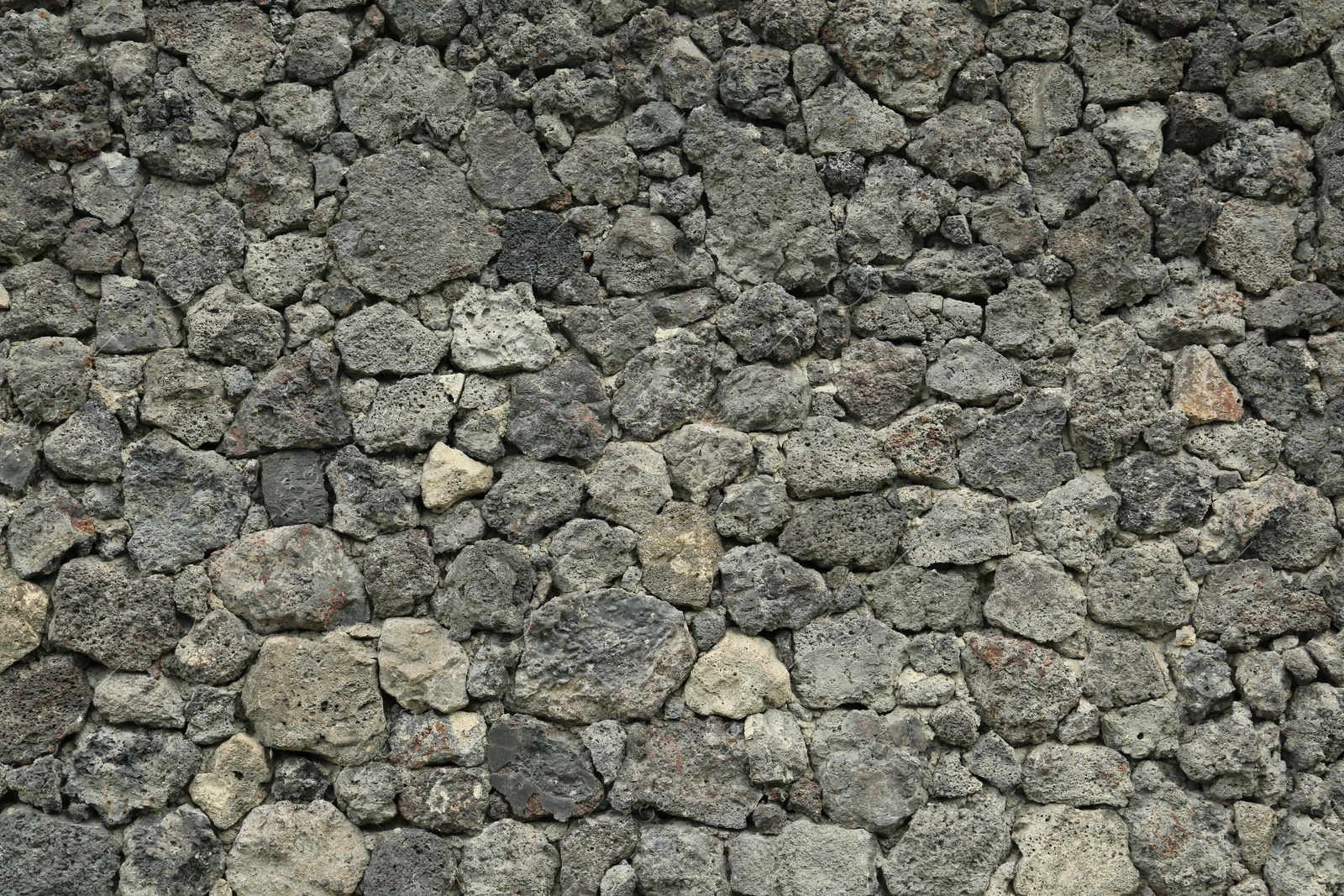 Photo of Texture of grey stone wall as background