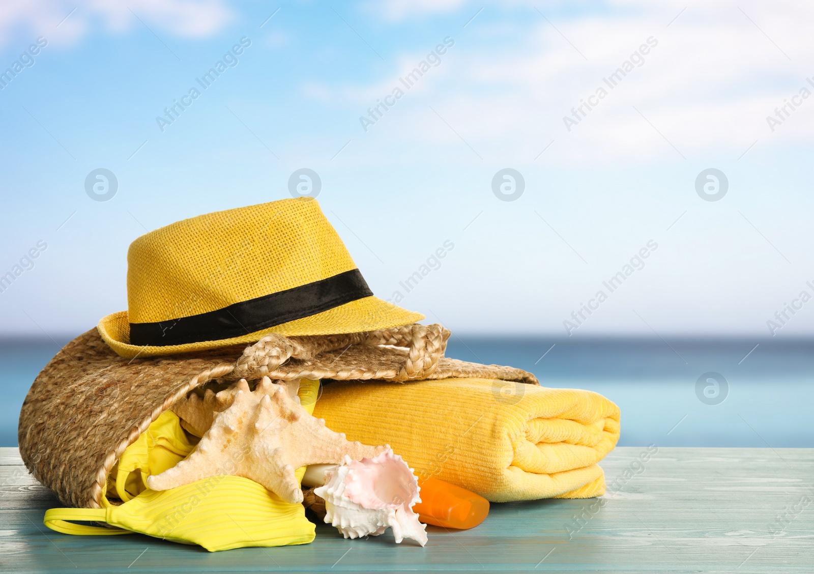 Image of Different beach objects on wooden surface near sea