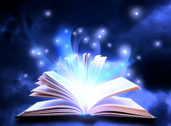 Image of Open book with fairytales and magic lights on blue background. Creative design