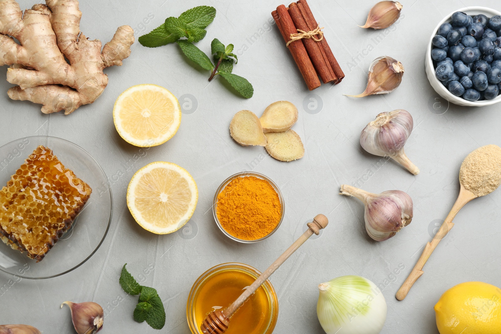 Photo of Flat lay composition with fresh products on grey table. Natural antibiotics