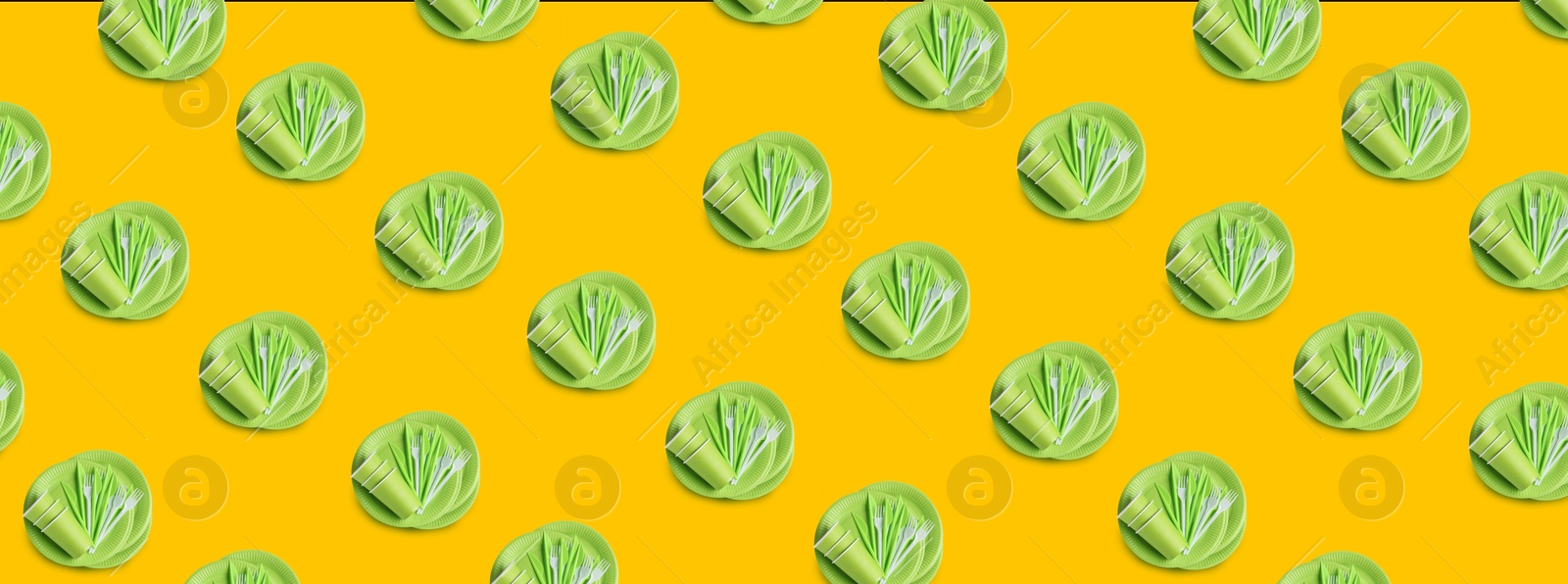 Image of Many disposable tableware on yellow background, flat lay. Seamless pattern design