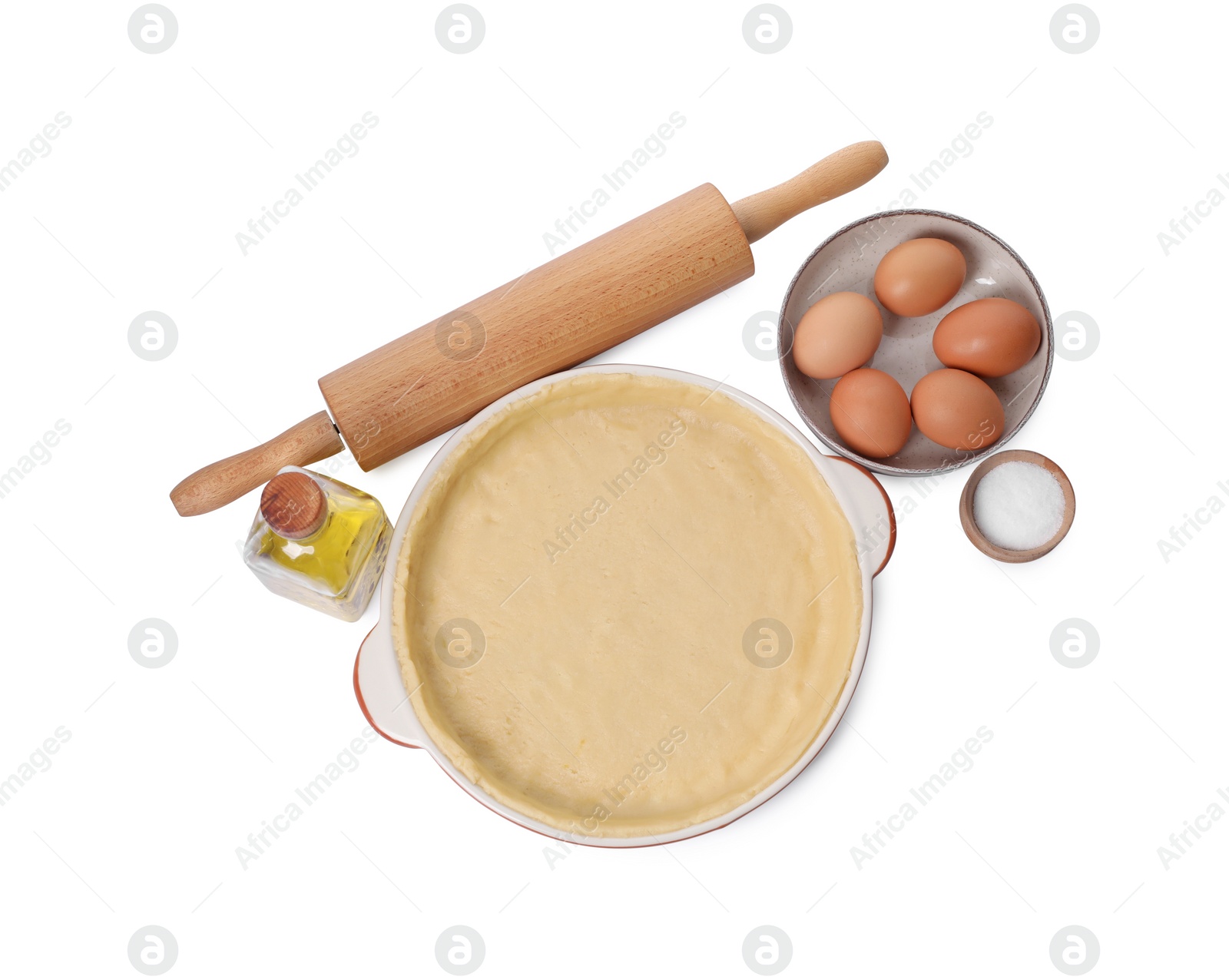 Photo of Pie tin with fresh dough, rolling pin and ingredients isolated on white, top view. Making quiche