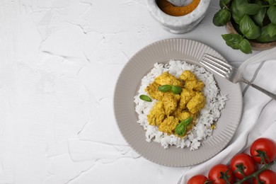 Photo of Delicious rice, chicken with curry sauce and products on white textured table, flat lay. Space for text