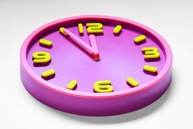 Photo of Clock showing five minutes until midnight on white background, closeup. New Year countdown