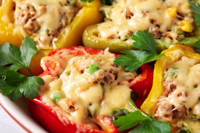 Photo of Tasty stuffed bell peppers in baking dish, closeup