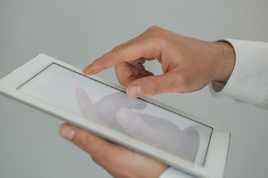 Closeup view of man using new tablet indoors