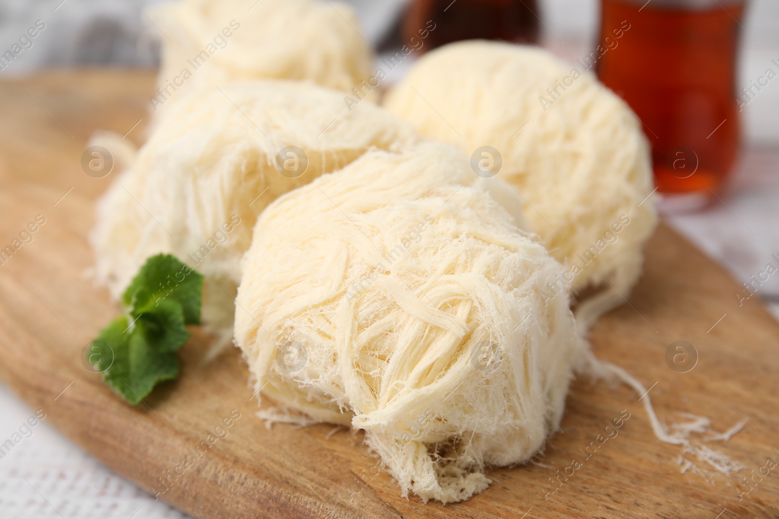 Photo of Eastern sweets. Tasty Iranian pashmak on white wooden table, closeup