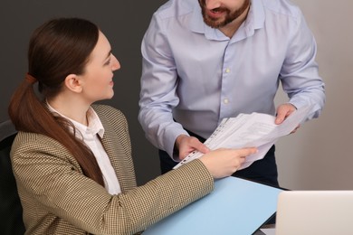 Businesspeople working together with documents in office