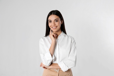 Portrait of young businesswoman on white background