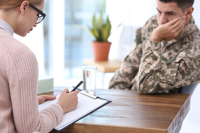 Photo of Psychotherapist working with military officer in office