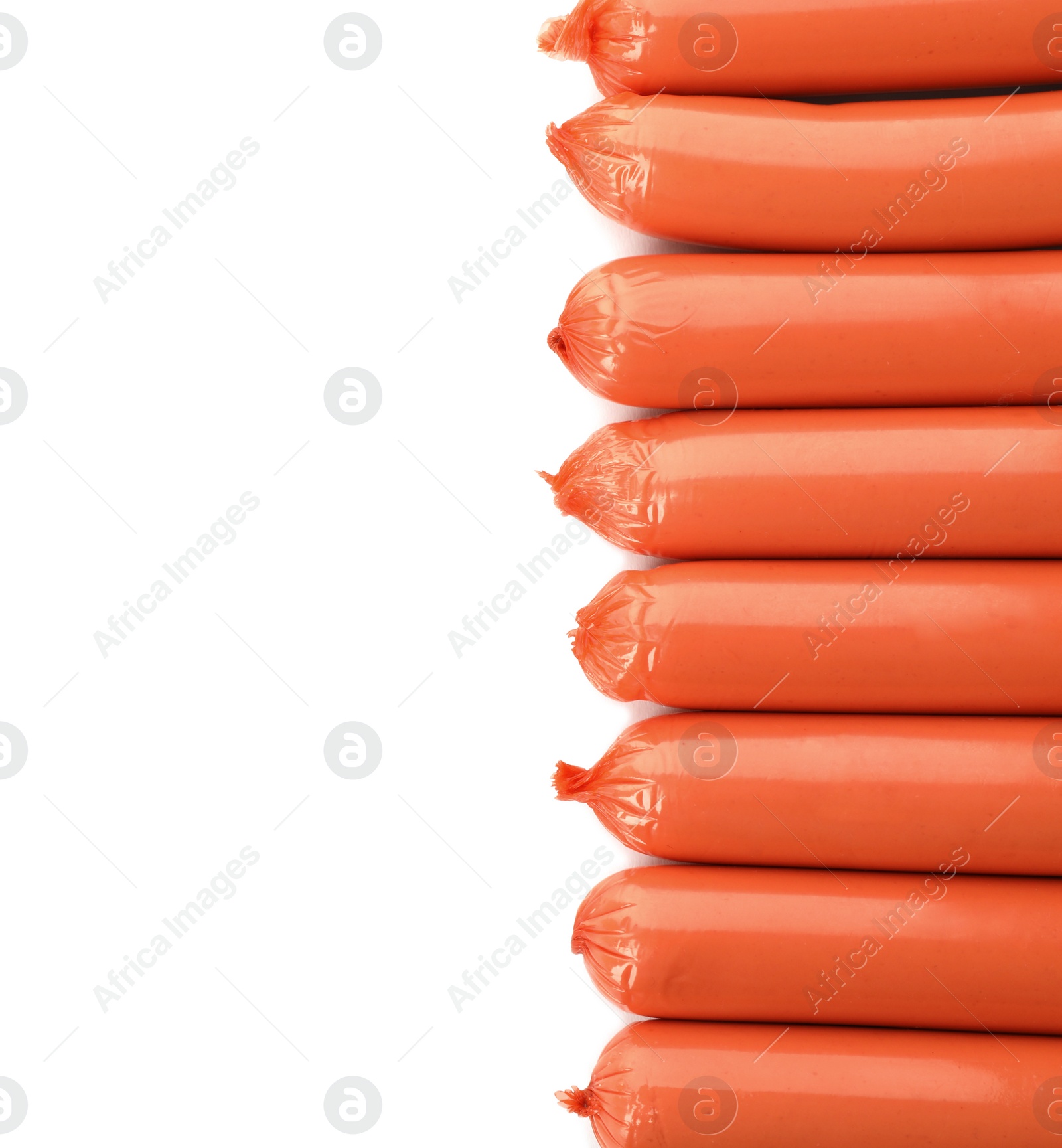 Photo of Encased sausages on white background, top view with space for text. Meat product