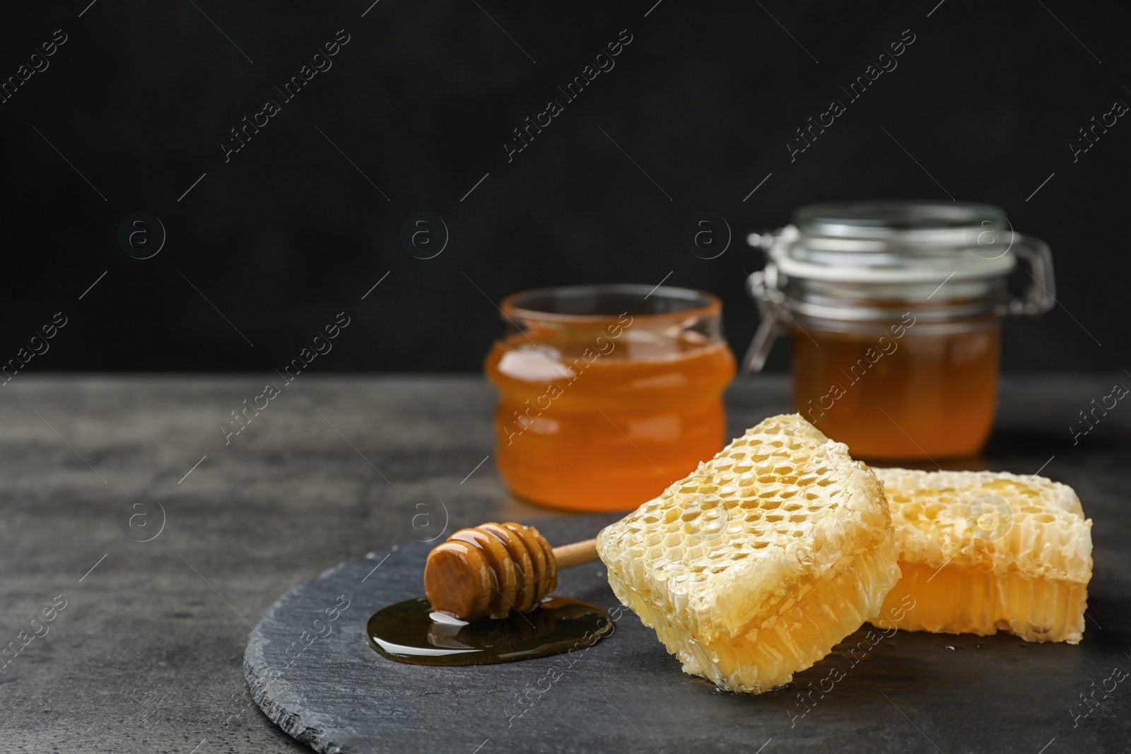 Photo of Slate plate with fresh honeycombs on table