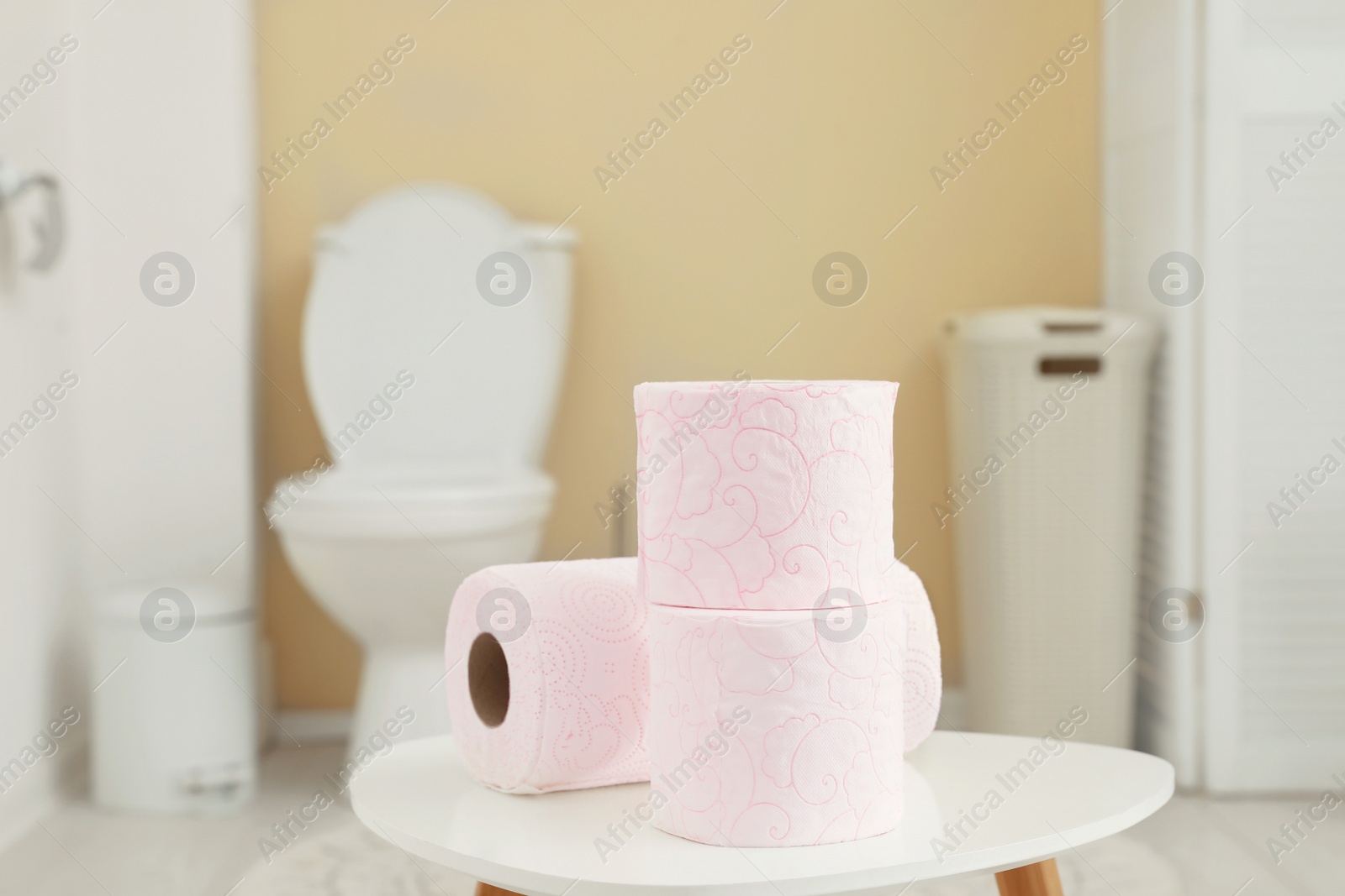 Photo of Toilet paper rolls on table in bathroom
