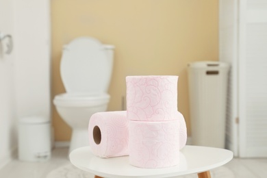 Toilet paper rolls on table in bathroom