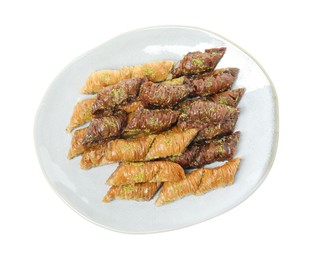 Plate of delicious baklava with pistachio nuts on white background, top view