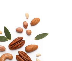 Different delicious nuts on white background, flat lay. Space for text