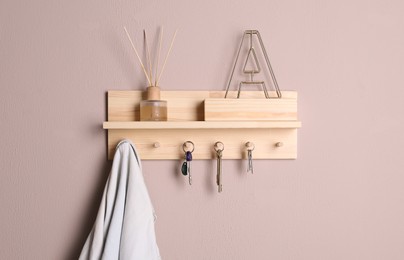 Photo of Wooden hanger for keys on color wall