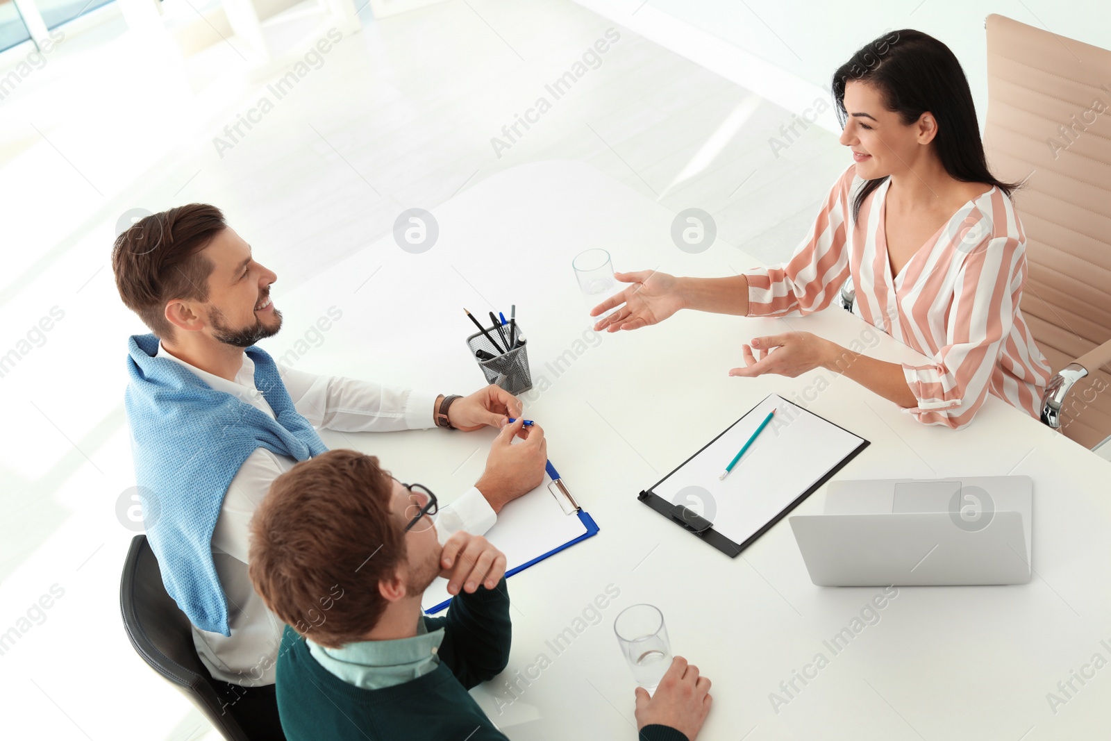 Photo of Human resources manager conducting job interview with applicants in office