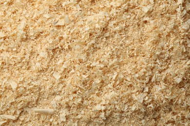 Photo of Dry natural sawdust as background, top view