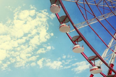 Beautiful large Ferris wheel against blue sky, low angle view