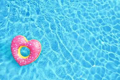 Image of Swimming pool with inflatable ring, top view. Space for text