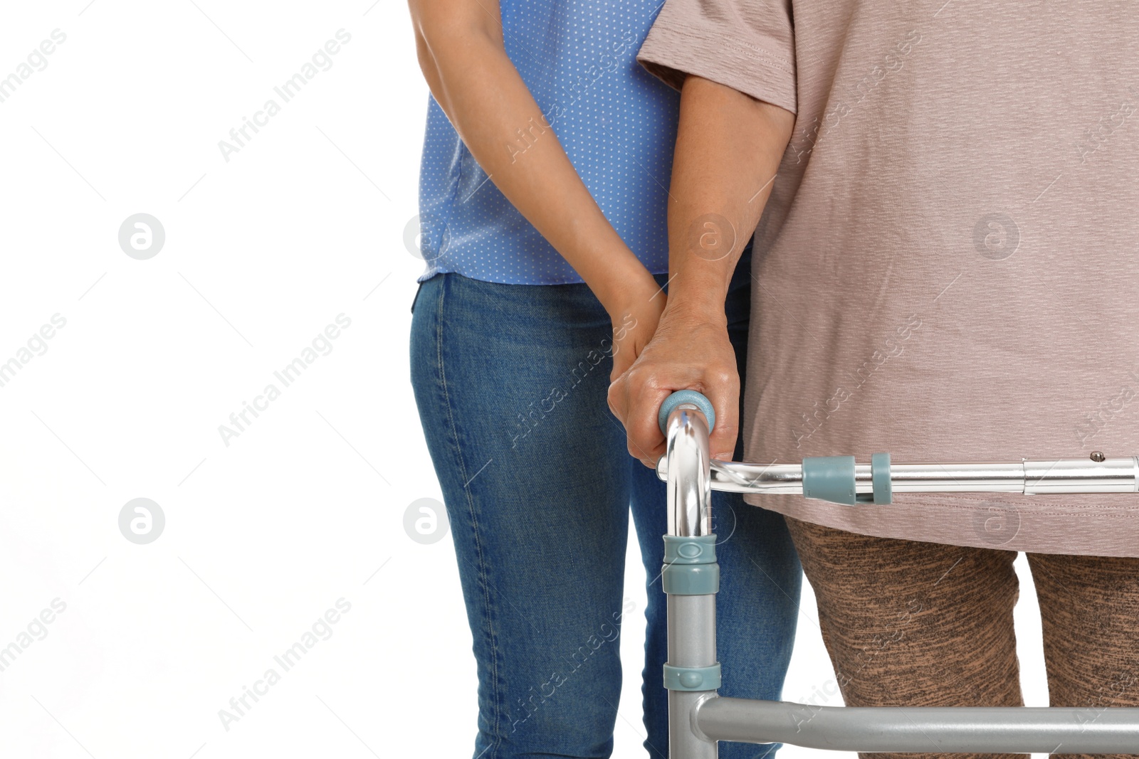 Photo of Caretaker helping elderly woman with walking frame on white background, closeup