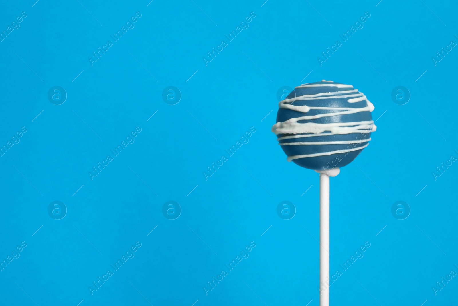 Photo of Bright delicious cake pop on color background. Space for text