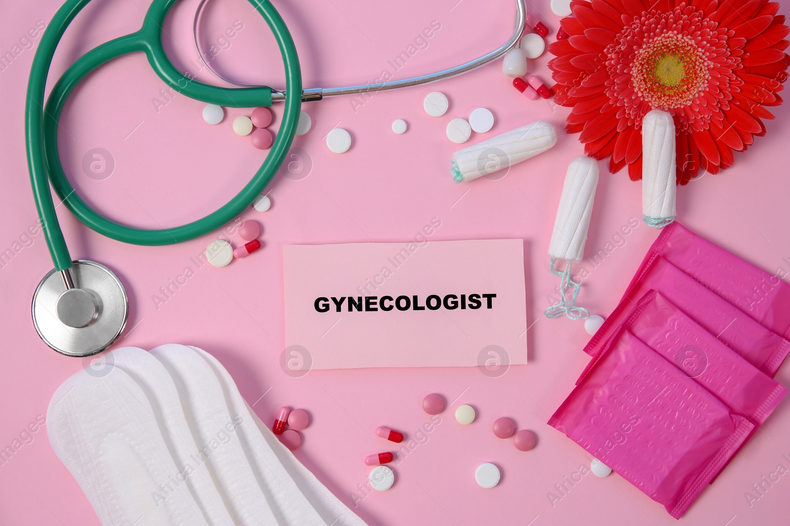 Photo of Flat lay composition with stethoscope, period supplies and pills on color background. Gynecological checkup