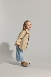 Photo of Fashion concept. Stylish girl posing on light grey background