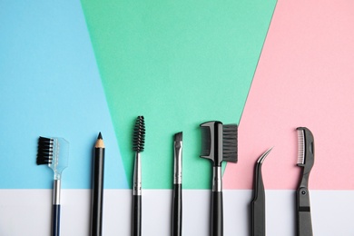 Photo of Set of professional eyebrow tools on color background, flat lay. Space for text