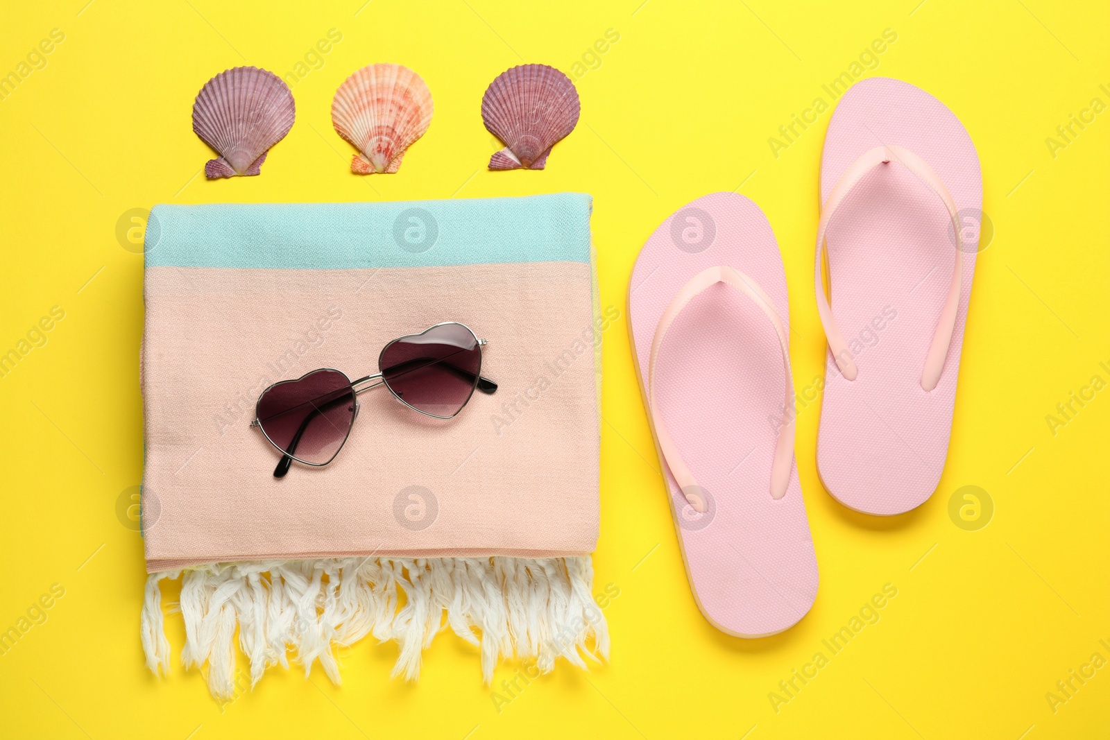 Photo of Flat lay composition with different beach objects on yellow background