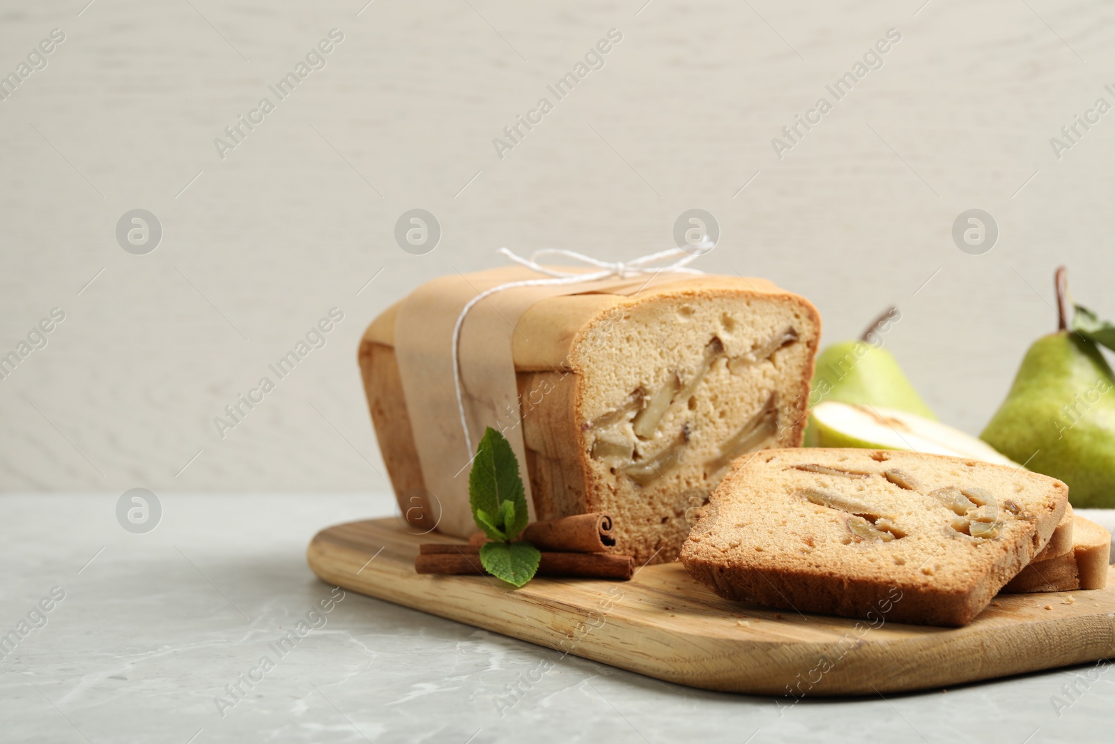 Photo of Tasty pear bread on light grey marble table. Homemade cake