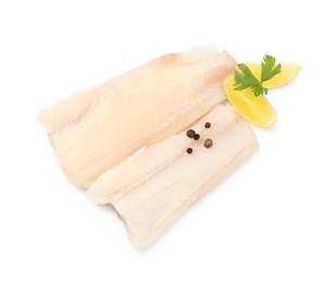 Photo of Pieces of raw cod fish, parsley, peppercorns and lemon isolated on white, top view