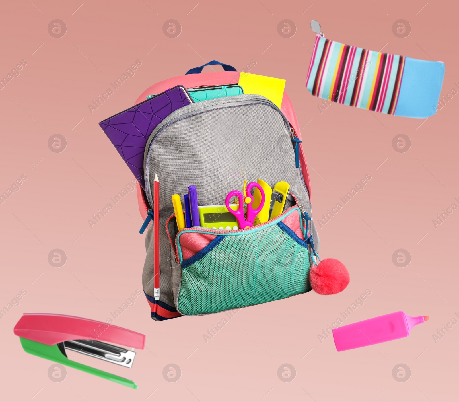 Image of Backpack surrounded by flying school stationery on color background