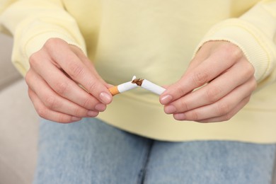 Photo of Stop smoking concept. Woman breaking cigarette, closeup