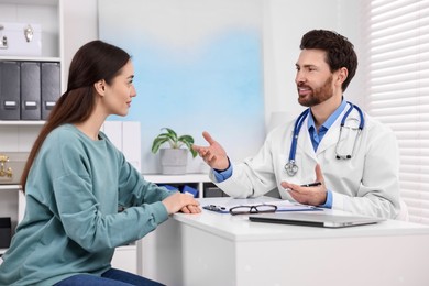 Doctor consulting patient during appointment in clinic