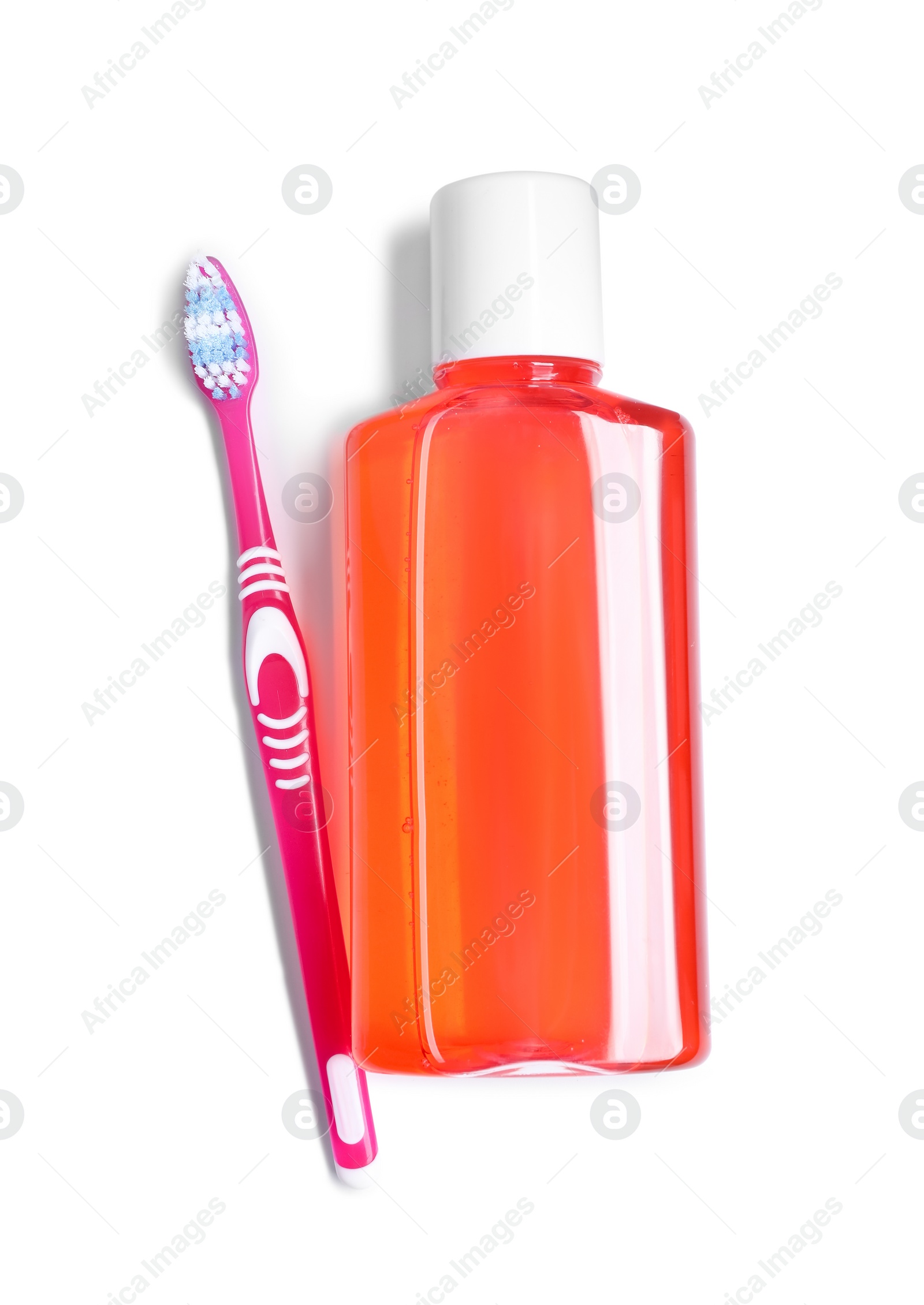 Photo of Fresh mouthwash in bottle and toothbrush isolated on white, top view