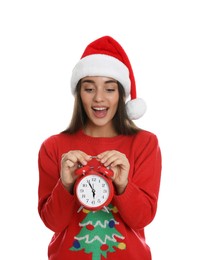 Woman in Santa hat with alarm clock on white background. New Year countdown