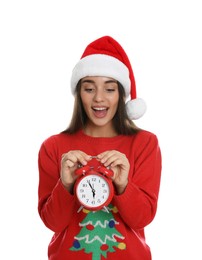 Photo of Woman in Santa hat with alarm clock on white background. New Year countdown