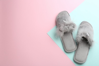 Photo of Pair of stylish soft slippers on color background, flat lay. Space for text