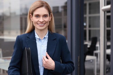 Real estate agent with leather portfolio near office outdoors. Space for text