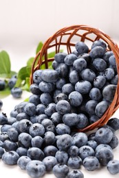 Photo of Tasty fresh blueberries on white wooden table, closeup
