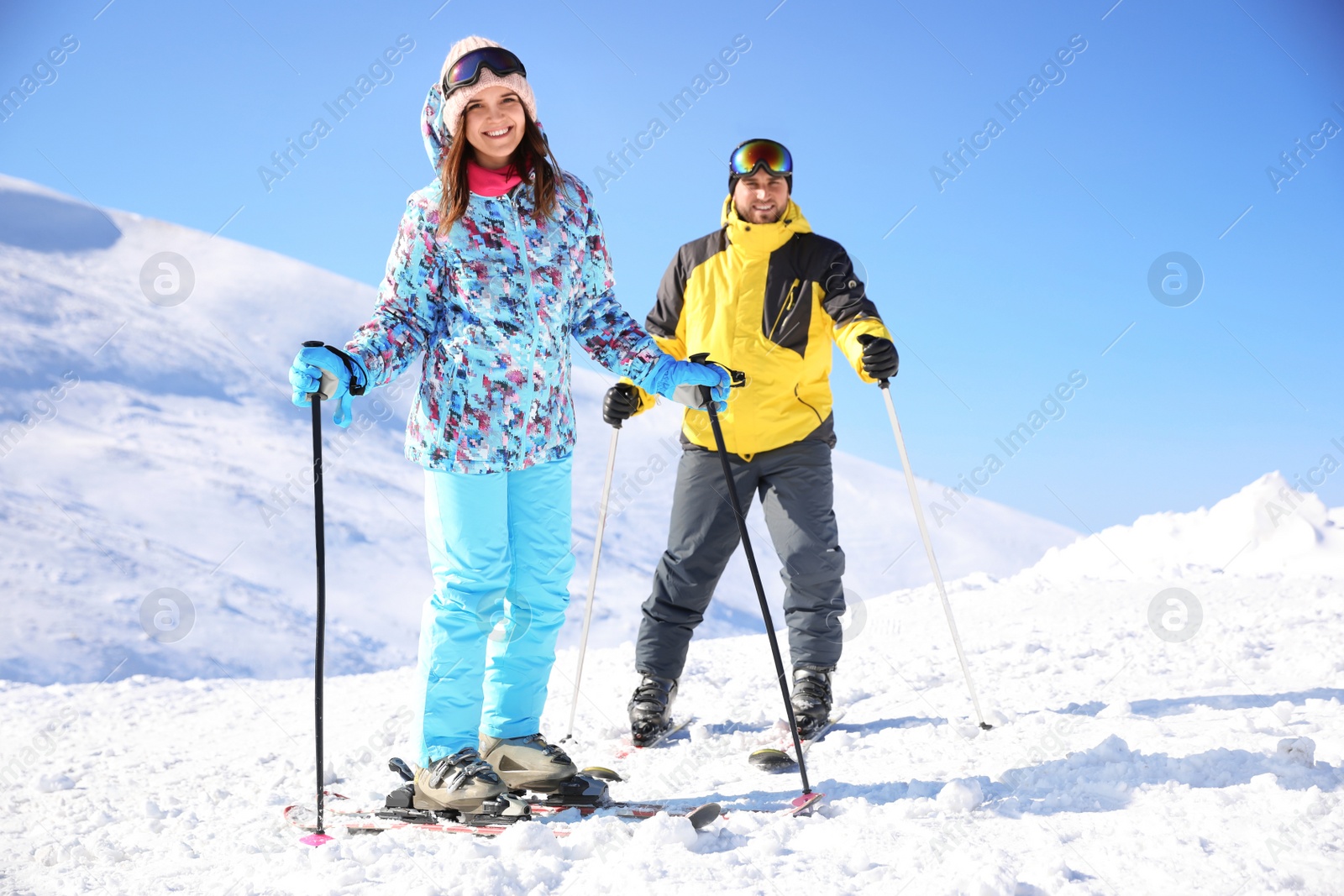 Photo of Young couple skiing on hill. Winter vacation