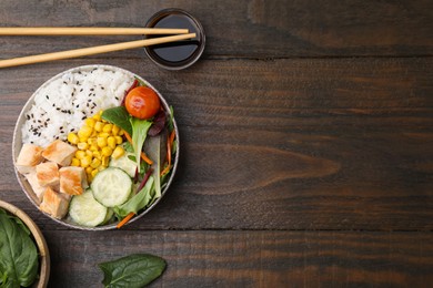 Photo of Delicious poke bowl with meat, rice, vegetables and greens served on wooden table, flat lay. Space for text