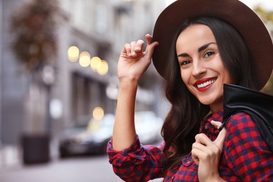Photo of Beautiful woman wearing hat in city on autumn day