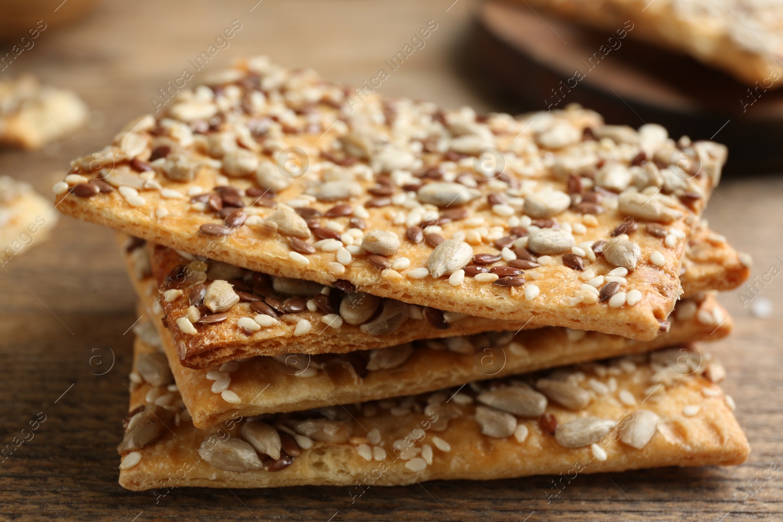 Photo of Stack of delicious crackers on table, closeup