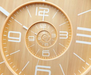 Image of Infinity and other time related concepts. Wooden clock face twisted in spiral, fractal pattern