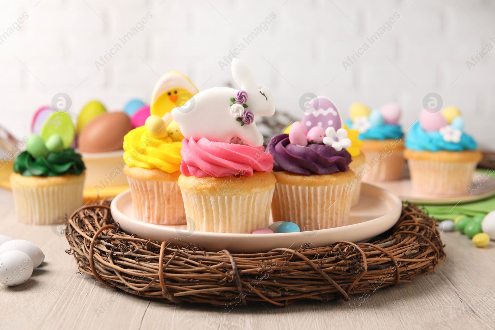 Photo of Tasty decorated Easter cupcakes on wooden table